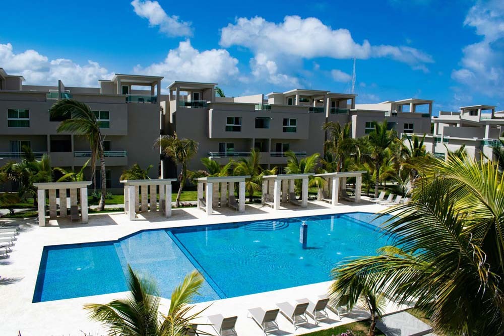 View of the buildings and pool at Beach Apartamentos at Playa Palmera